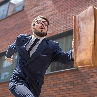 young businessman running in a city street