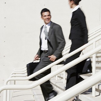 Hispanic businesspeople walking down stairs