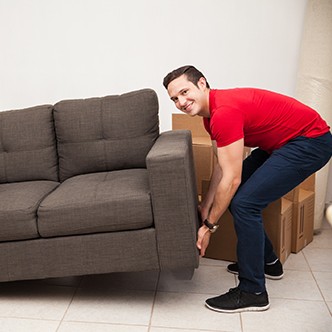 Couple trying to move a sofa