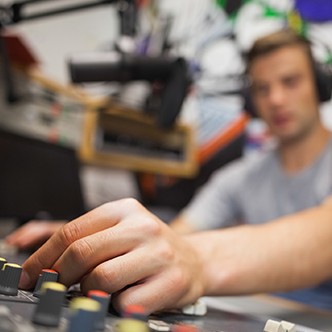 Handsome radio host moderating touching switch