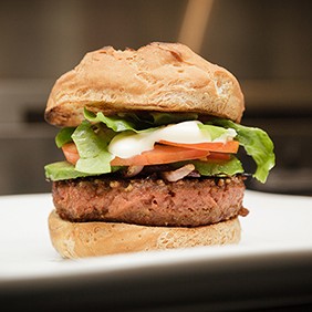 Organic burger made with Beyond Burger Veggie pattie on a gluten free bun in the kitchen