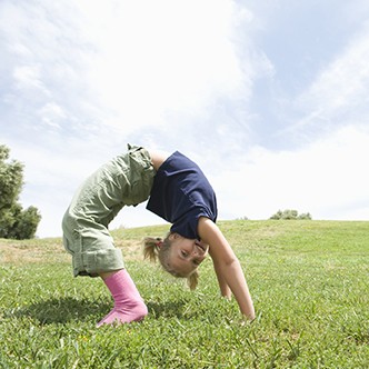 Bending over backwards, girl on grass