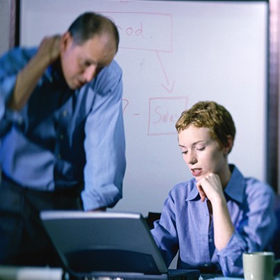 Businessman and a businesswoman working on a laptop