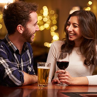 Couple Enjoying Evening Drinks In Bar